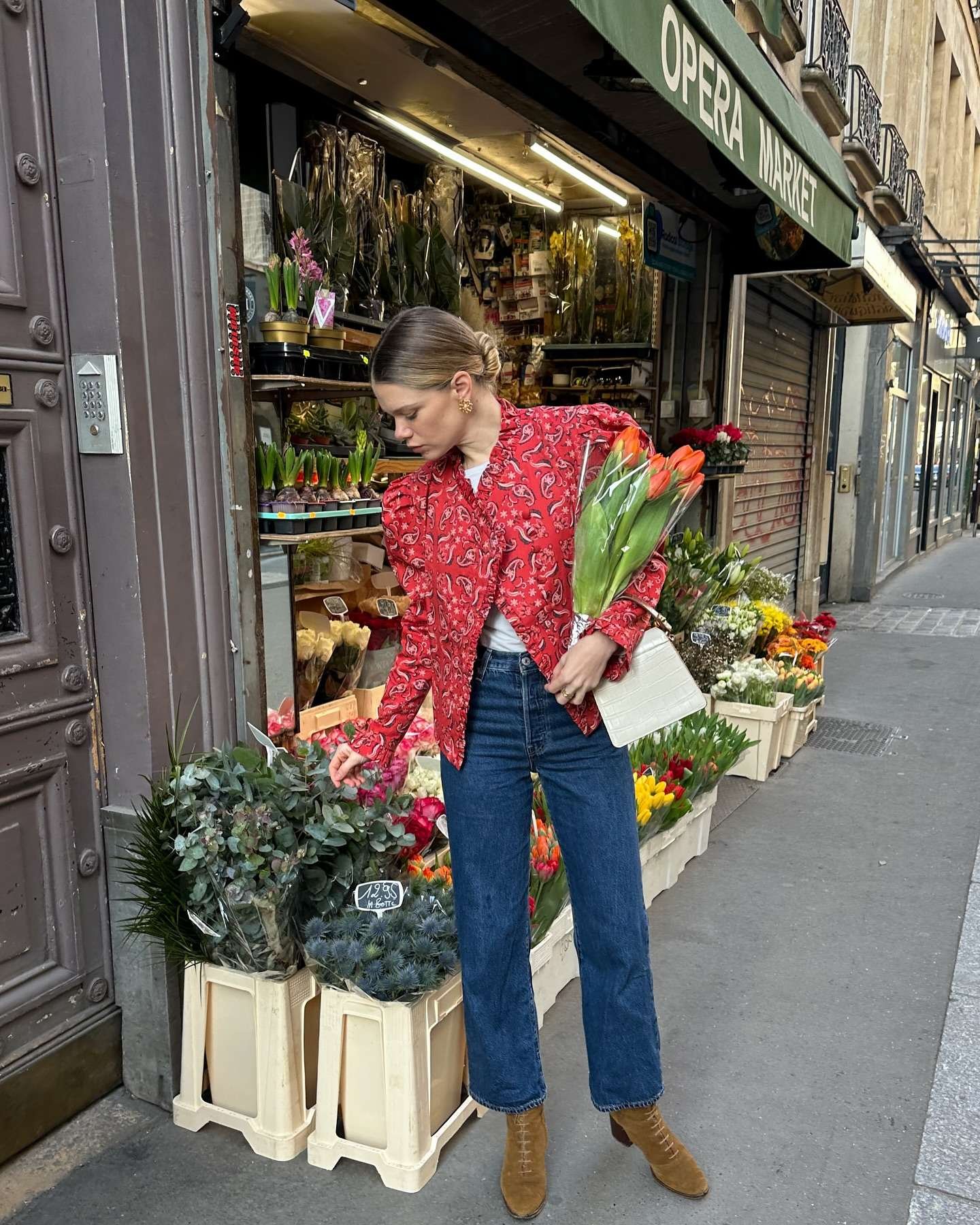 Patterned red top with blue jeans