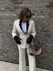 White suit with black accents, sophisticated spring look