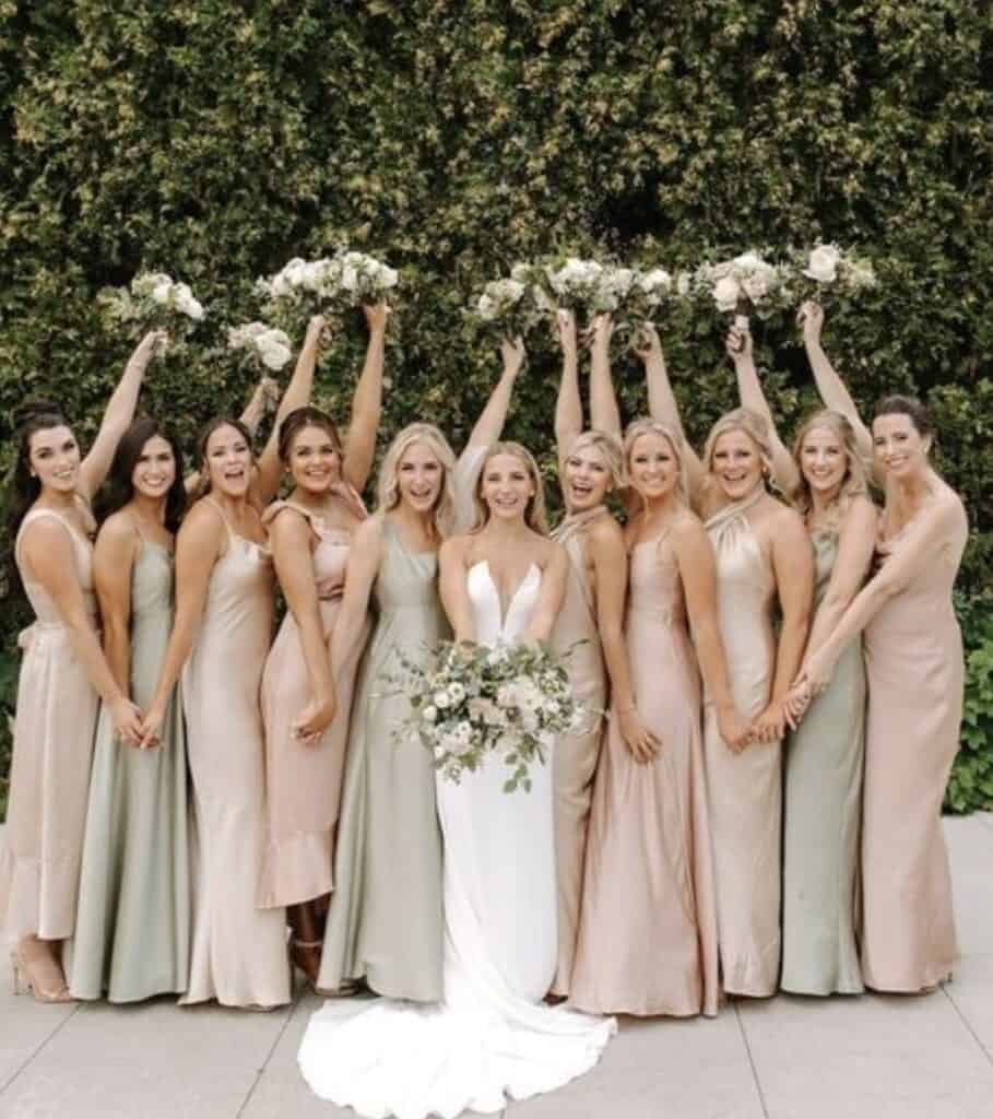 Bridesmaids in pastel dresses holding bouquets, elegant wedding style
