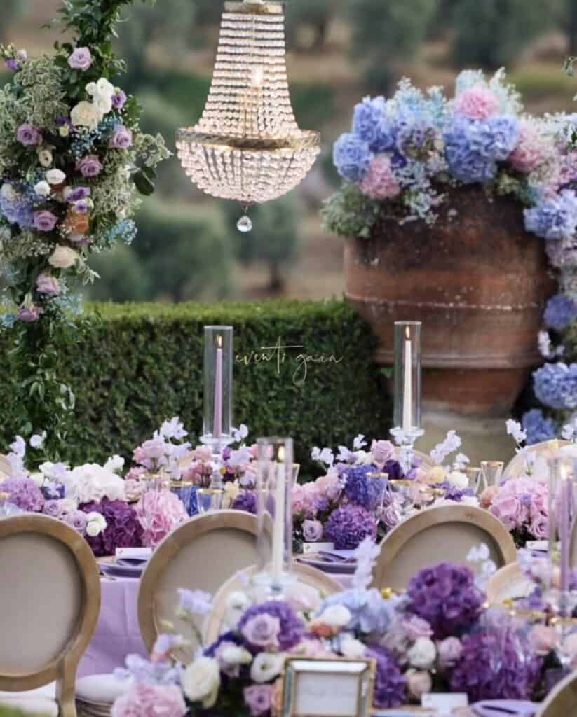 Lavender and lilac floral arrangements with elegant chandelier decor