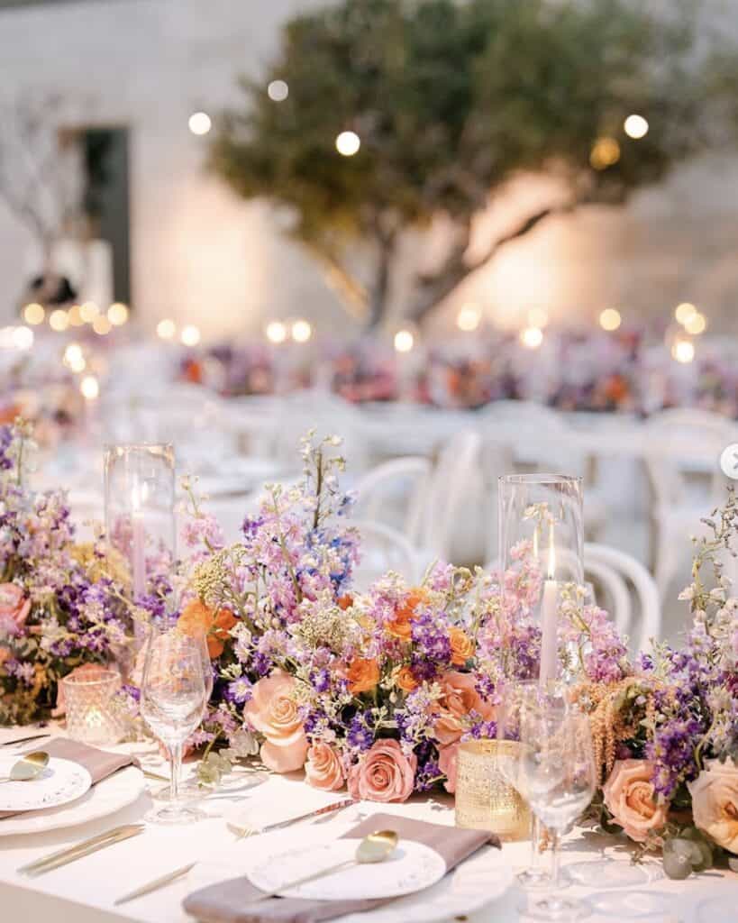Wedding table with lavender floral centerpiece and elegant table settings