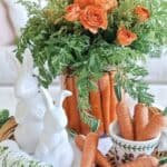 Whimsical carrot floral centerpiece with rabbit decor