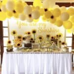 Wedding table with yellow balloons and sunflower decor