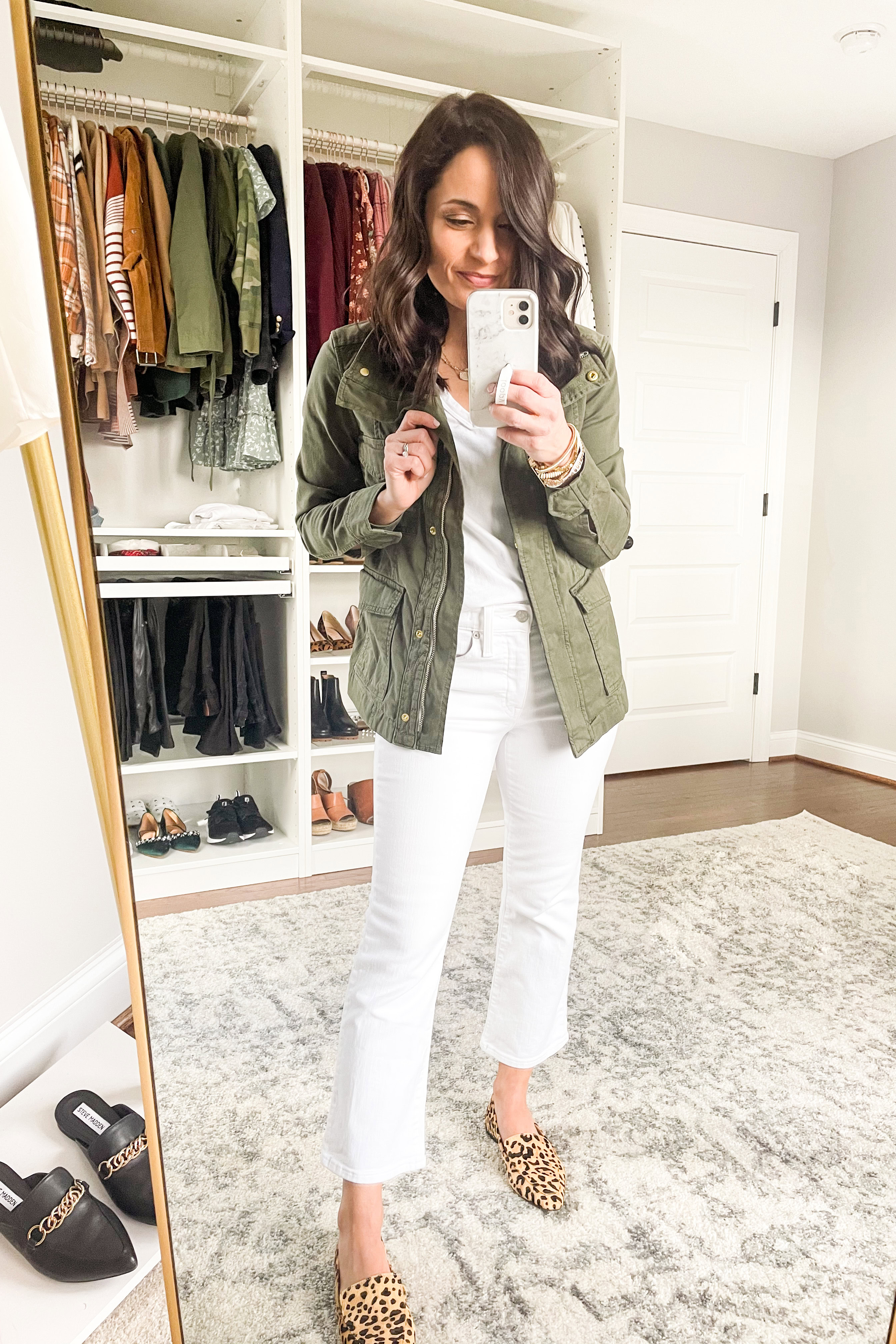 Woman in military jacket and white jeans, early spring style