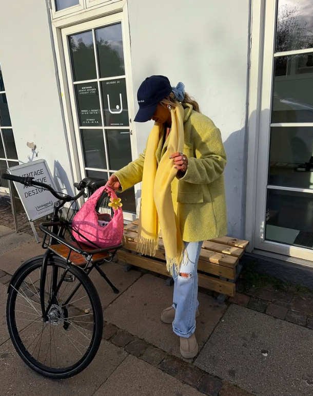 Woman in yellow coat and scarf, layered spring fashion