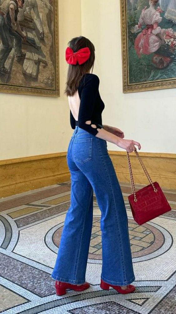 Backless top and flared jeans with red accessories, retro spring fashion
