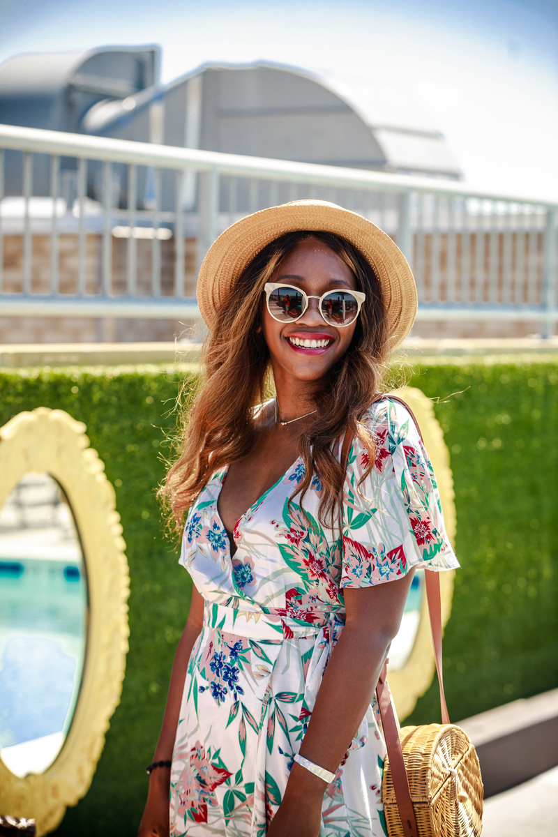 floral wrap dress with hat and sunglasses