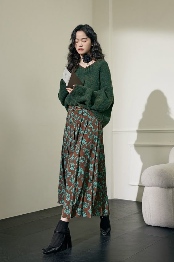 floral skirt with oversized sweater and boots
