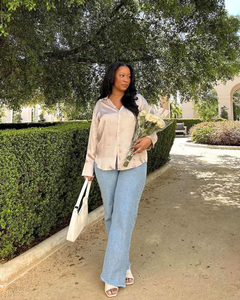 Woman in silk blouse and jeans, relaxed neutral style