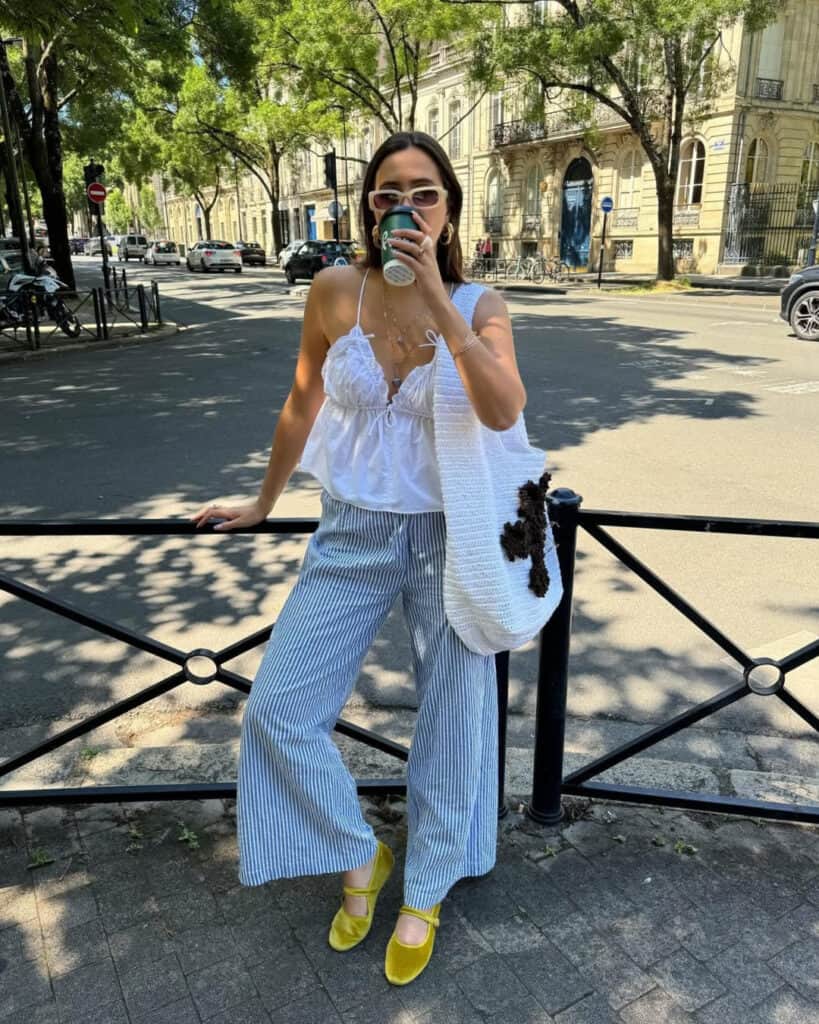 Woman in striped pants and lace top, elegant spring style