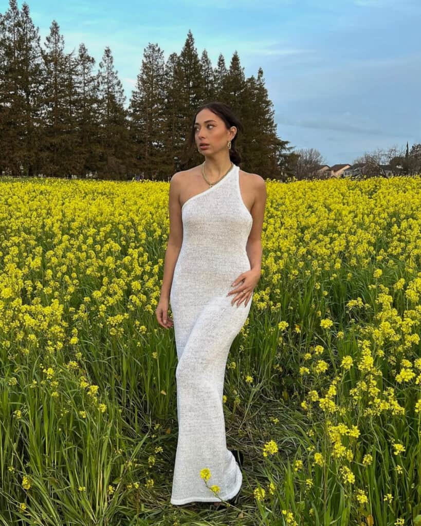 Woman in one-shoulder white dress, elegant spring style