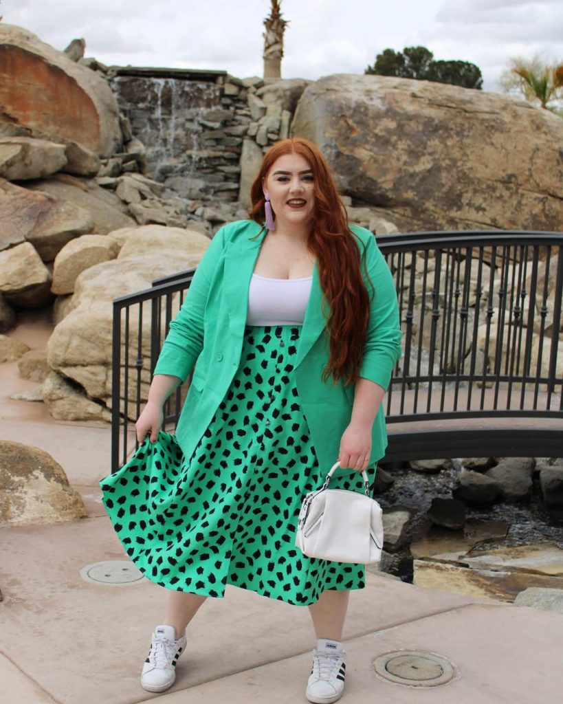 Plus size woman in green polka dot skirt and mint blazer, spring fashion.