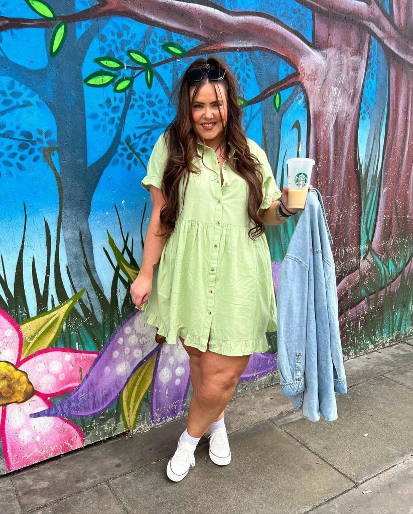 Plus size woman in light green shirt dress, casual spring fashion.