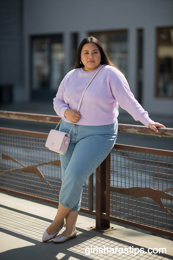 Plus size woman in lavender sweater and denim jeans, casual spring outfit.
