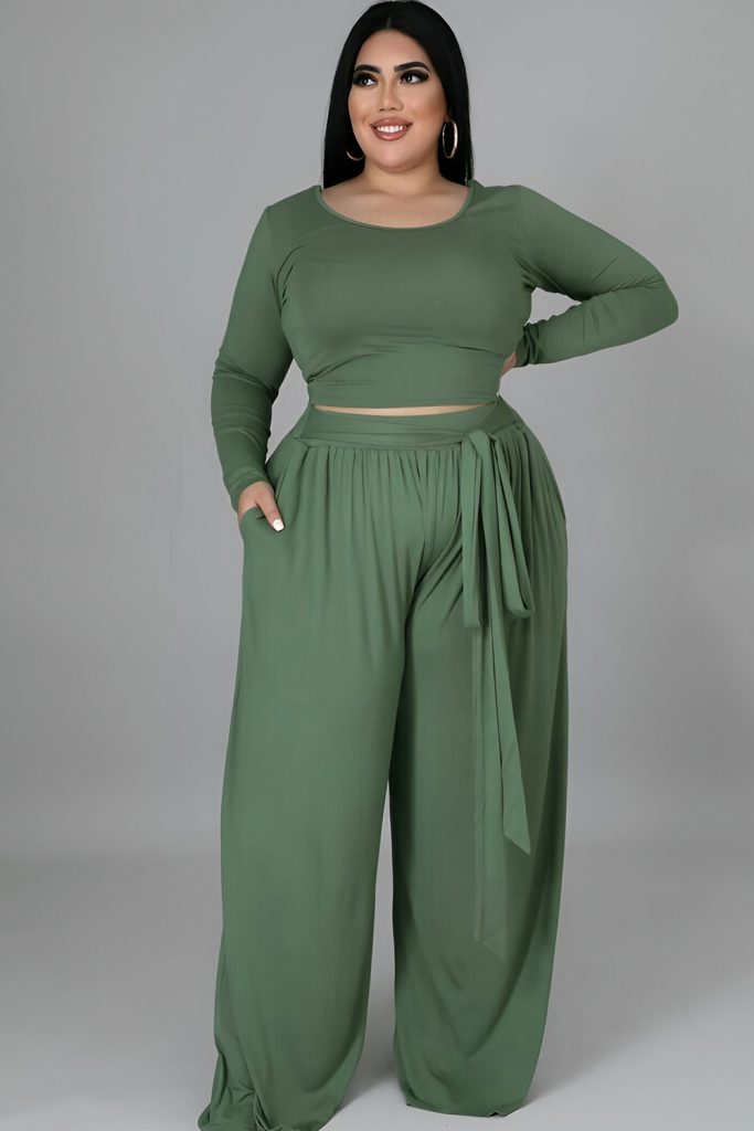 Plus size woman in green two-piece set, elegant monochrome style.