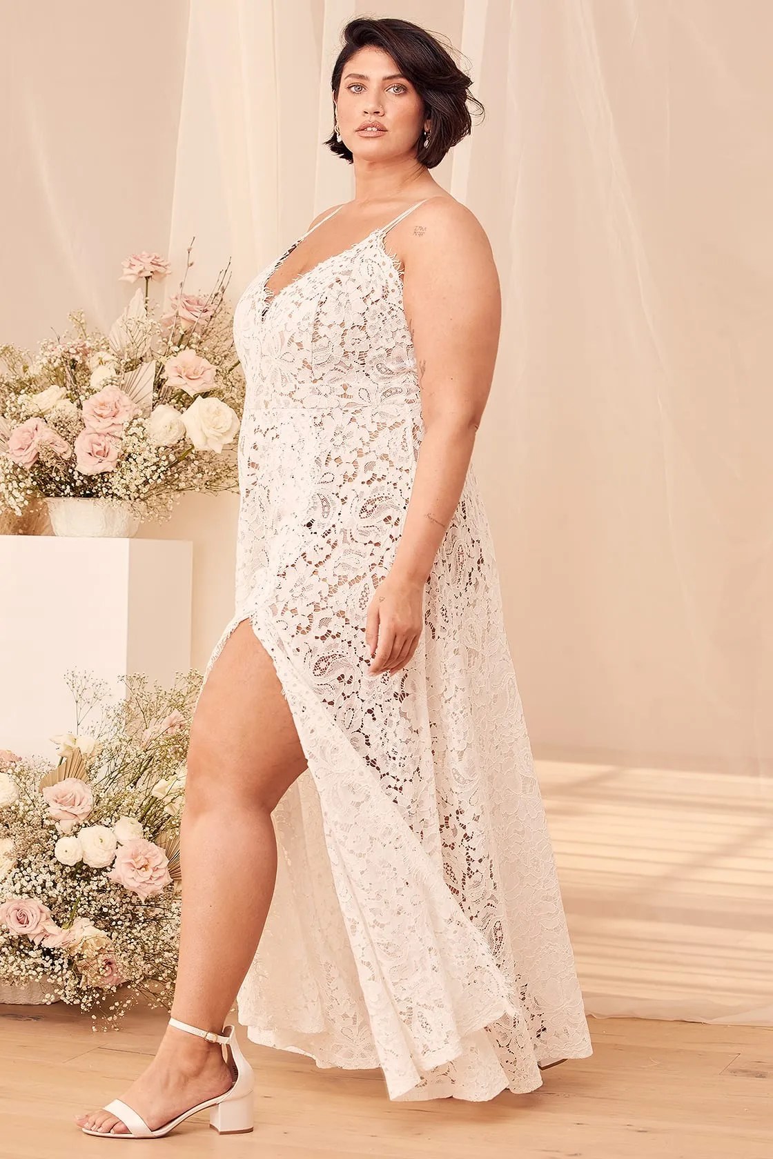 Bride wearing a lace bohemian dress with floral decor