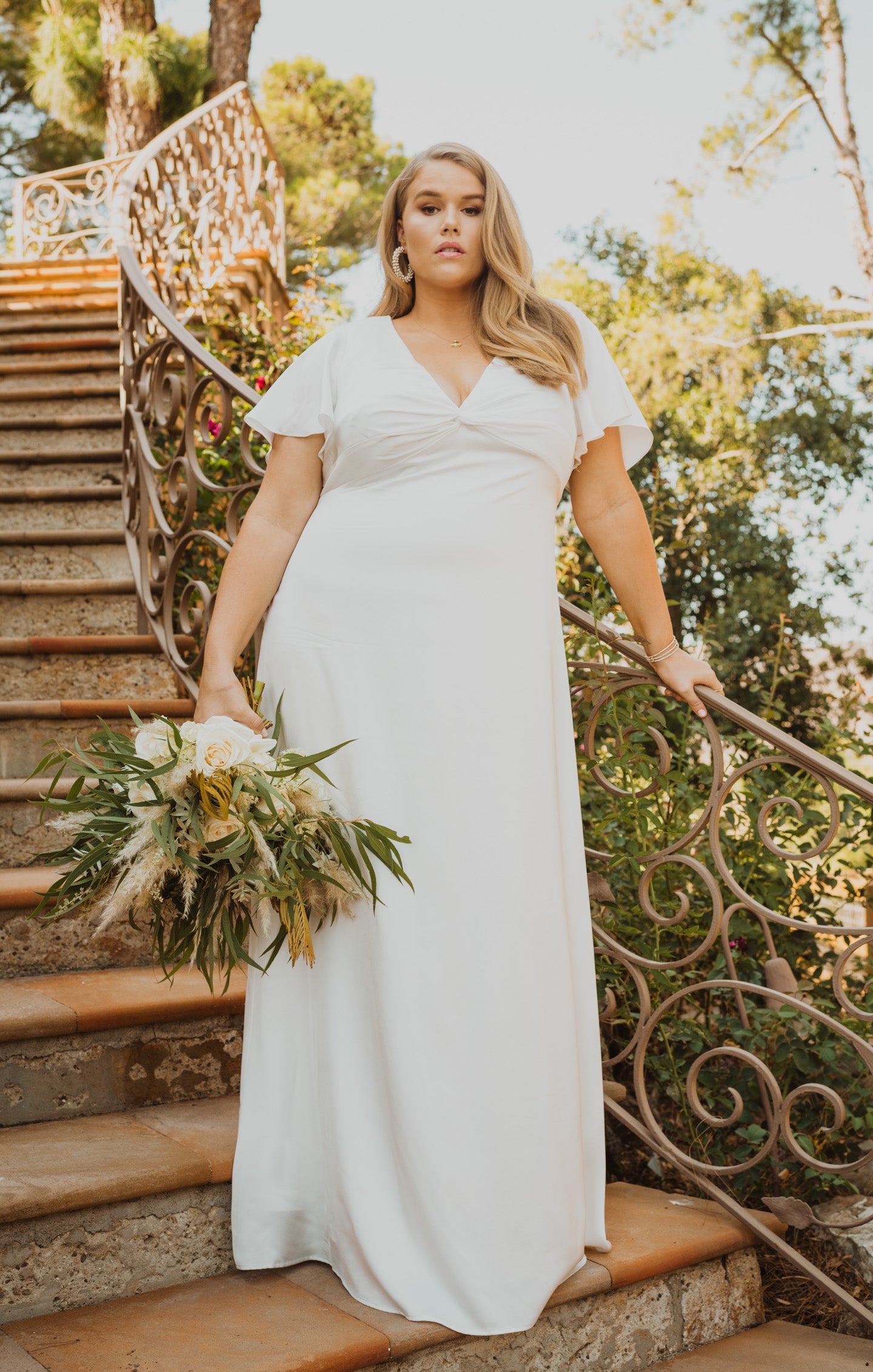 White boho wedding dress on stairs