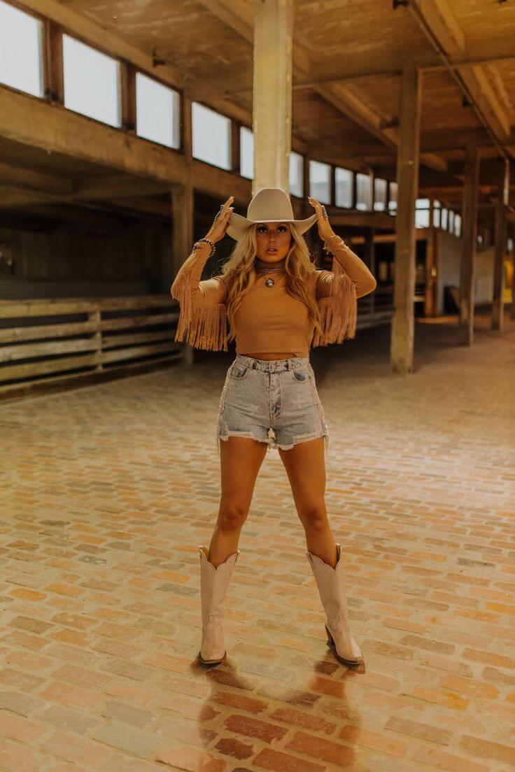 Fringe top with denim shorts and cowboy hat