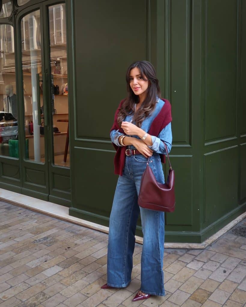 Double denim outfit with a bordeaux sweater and bag