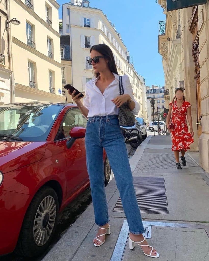 White blouse with high-waisted jeans and sandals