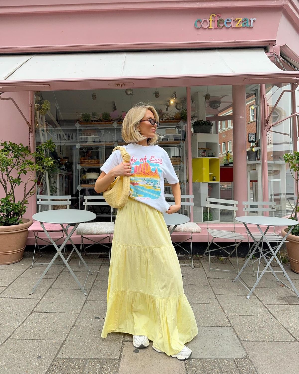 Woman in graphic tee and yellow maxi skirt