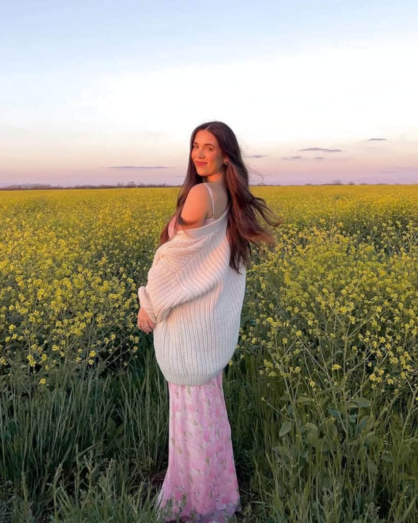 White knit sweater over floral dress, spring romance fashion 2026