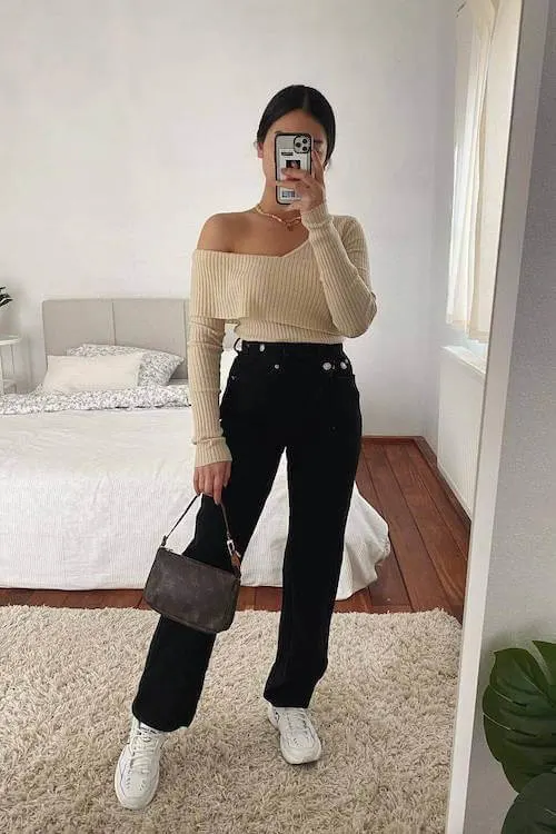 Off-shoulder sweater with black jeans, minimal spring fashion 2026