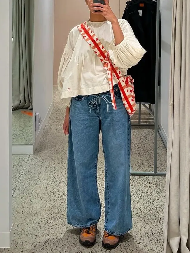 White voluminous top with wide-leg jeans, playful spring style 2026