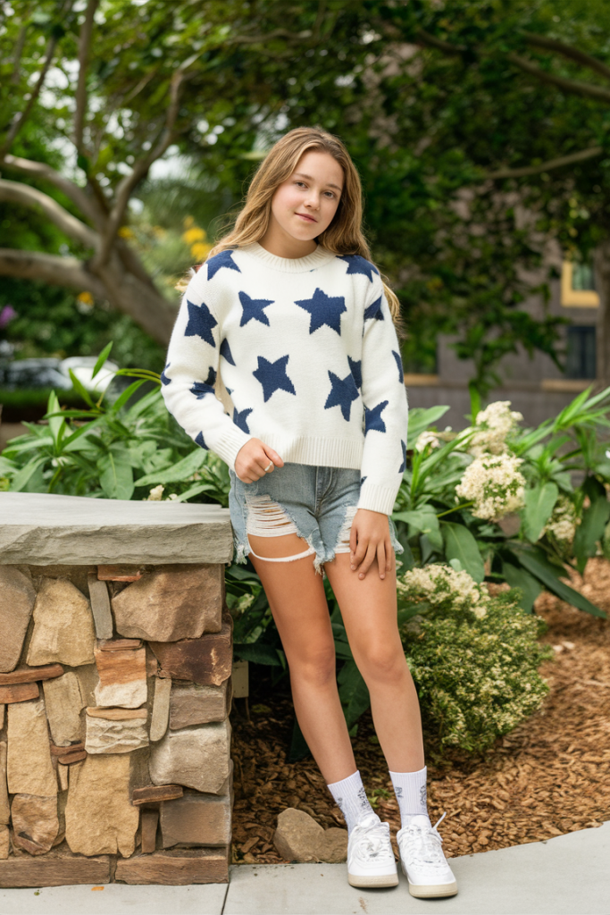 Teen girl in star-patterned sweater and denim shorts, casual spring style