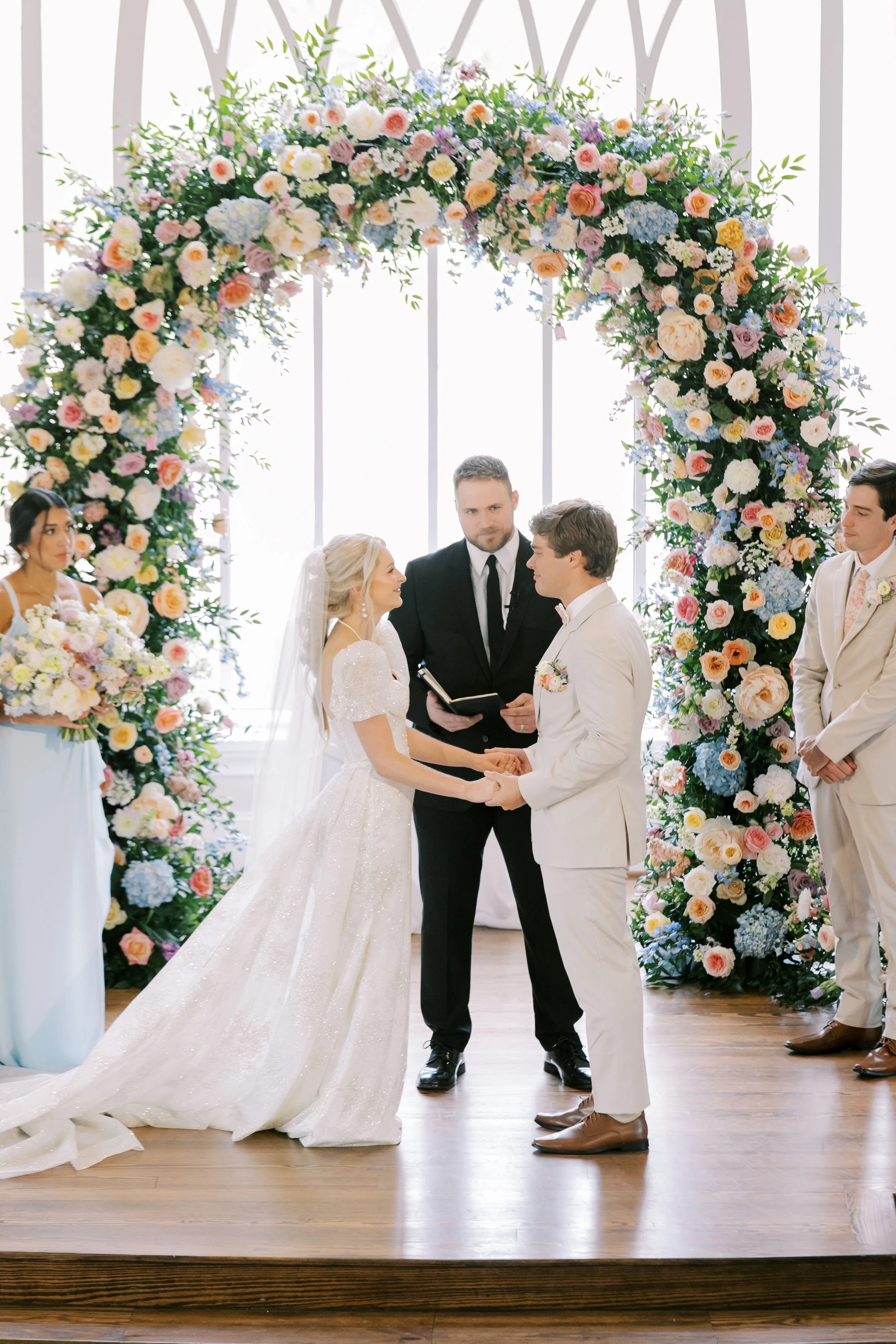 Floral archway at a garden wedding, romantic spring ceremony