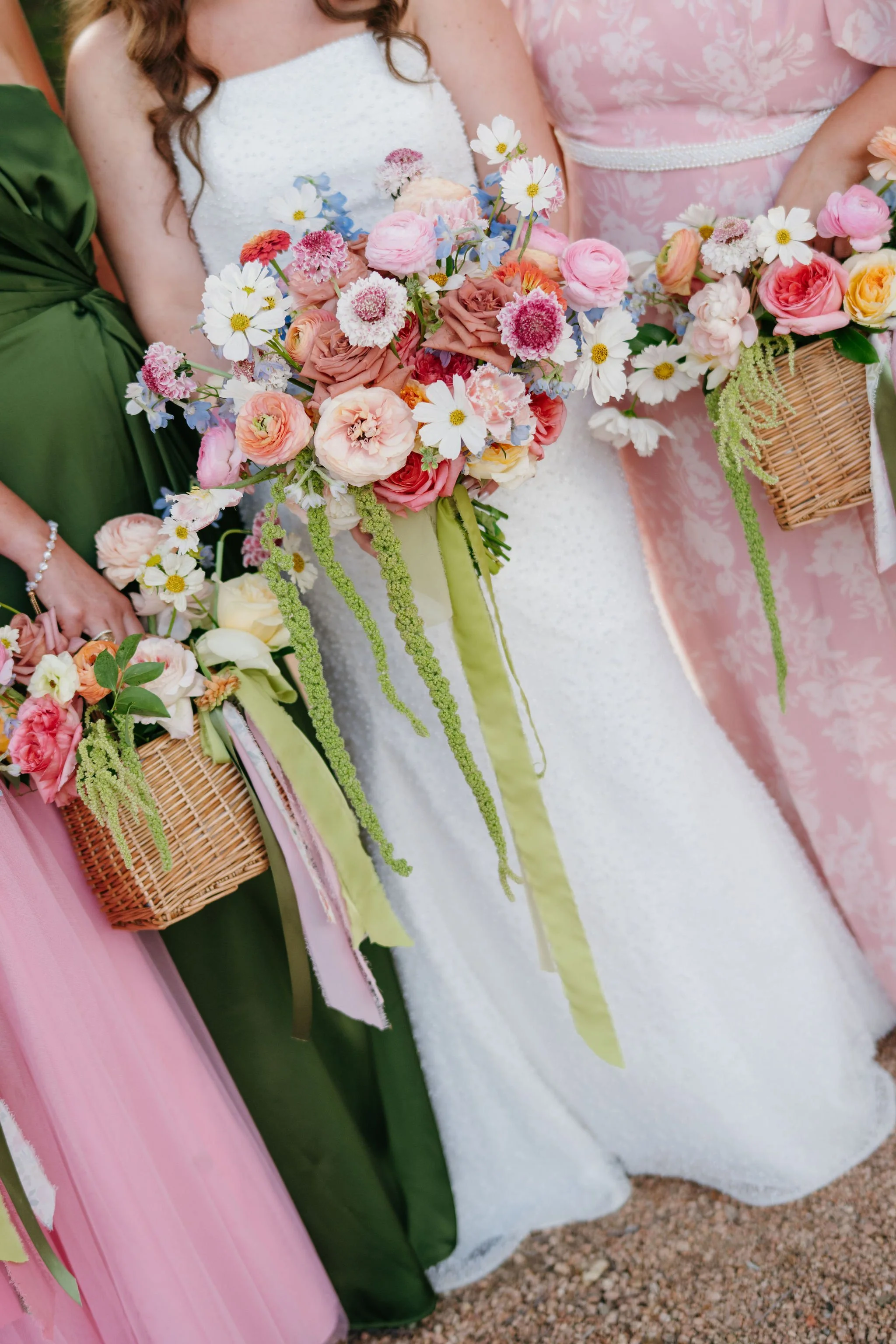 Rustic bridesmaid bouquets with mixed flowers in baskets, charming spring wedding