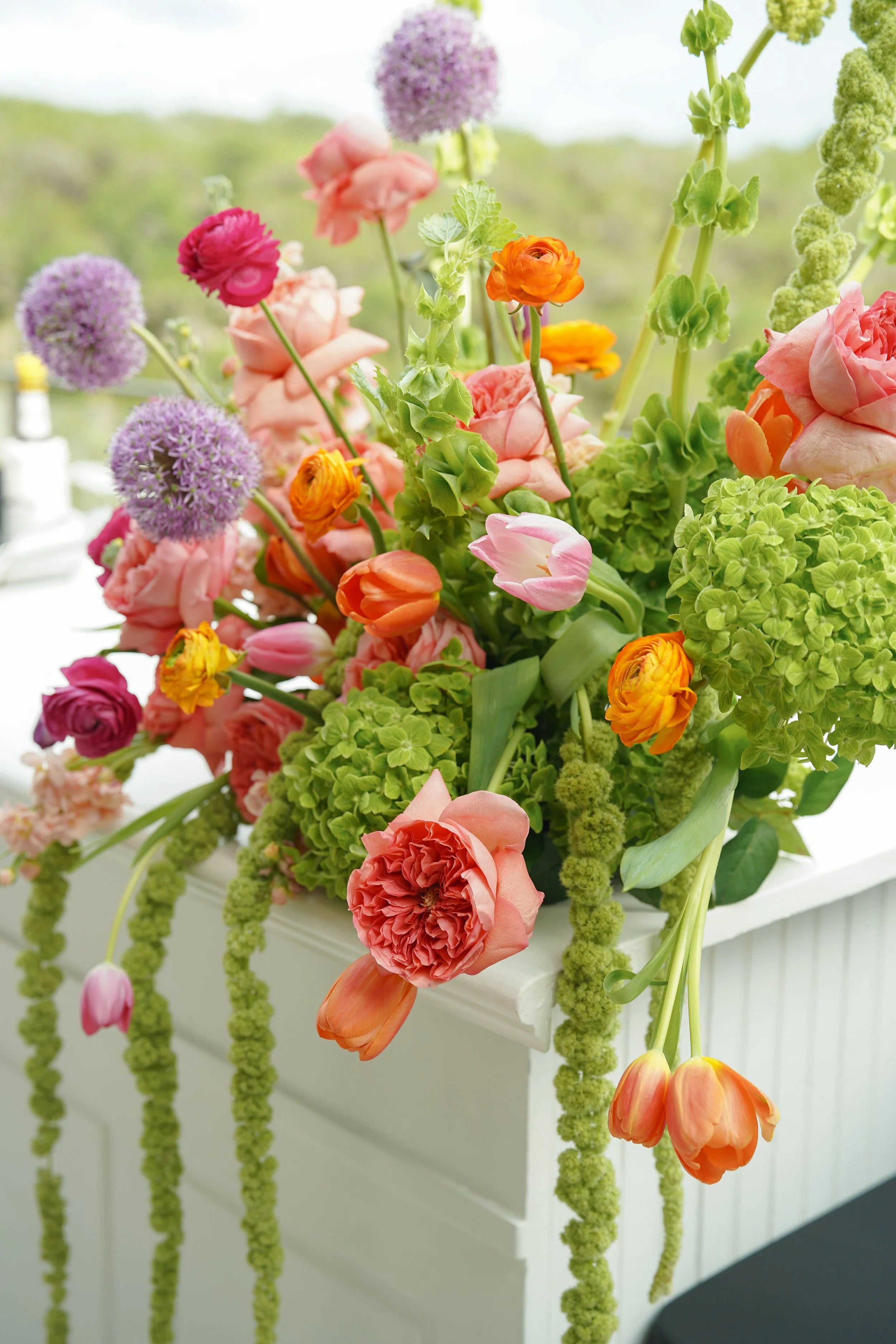 Bold floral arrangement with mixed bright colors, lively spring wedding