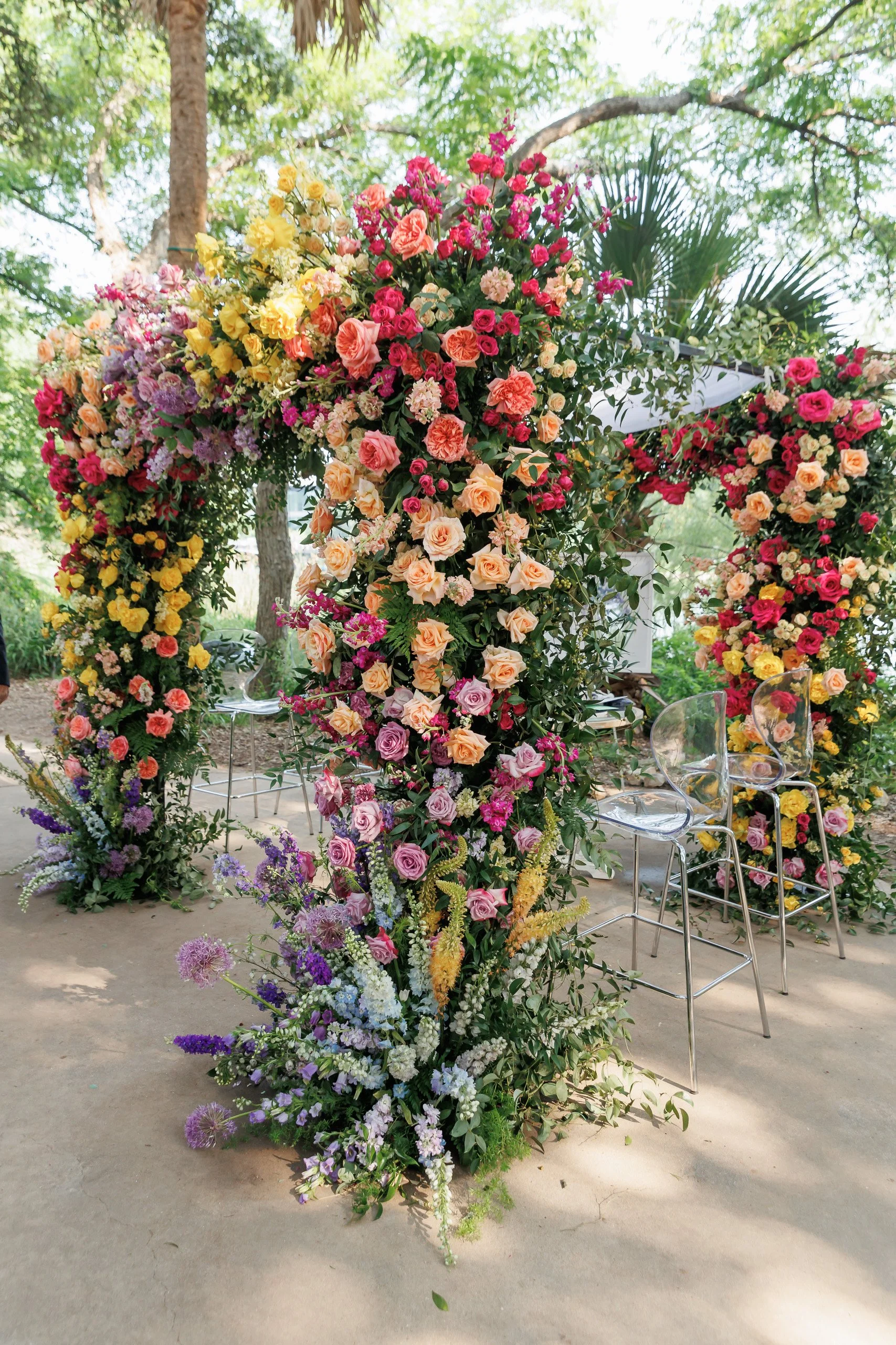 Colorful floral decor at outdoor wedding, vibrant spring setting