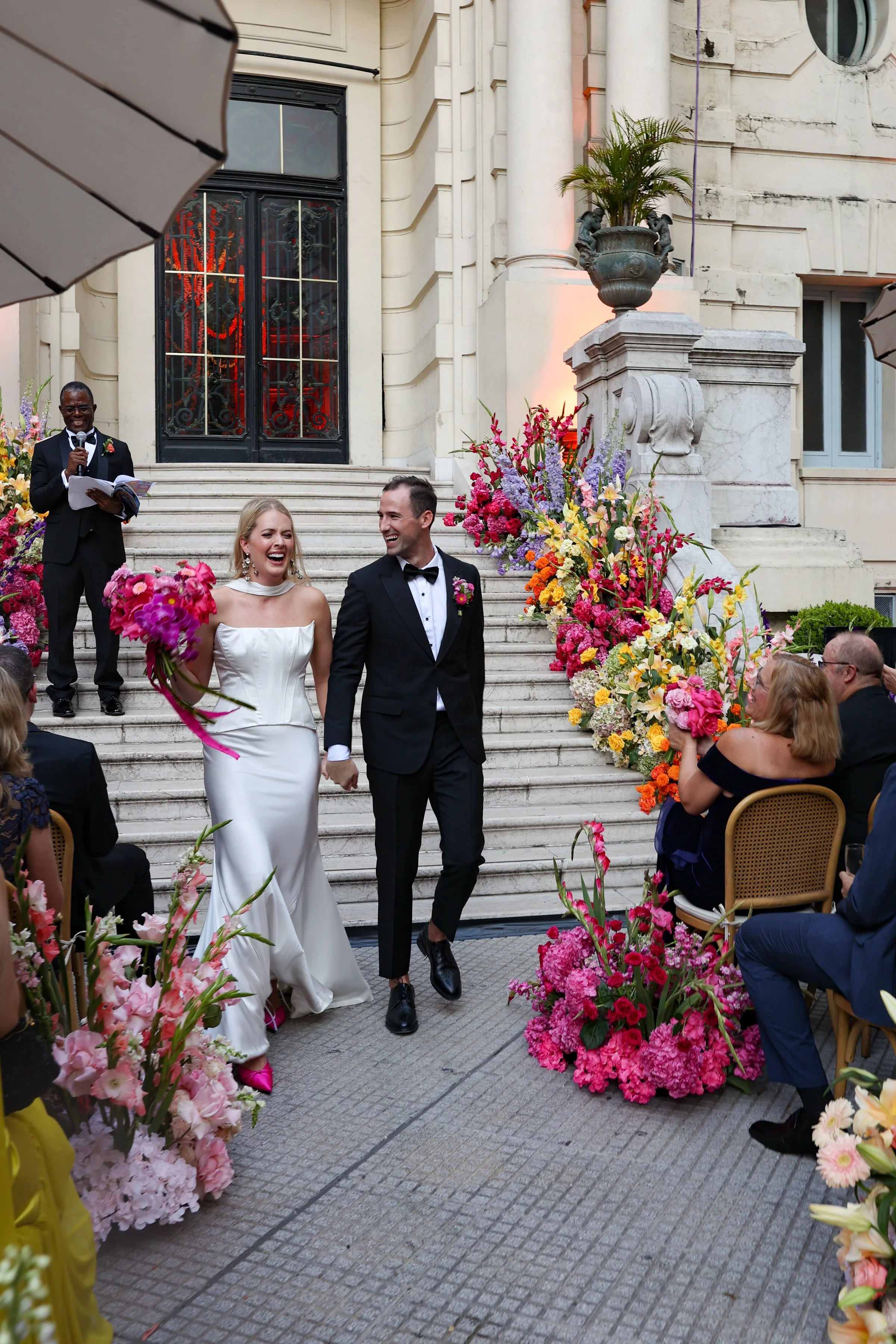 Vibrant floral aisle at outdoor wedding, festive spring celebration