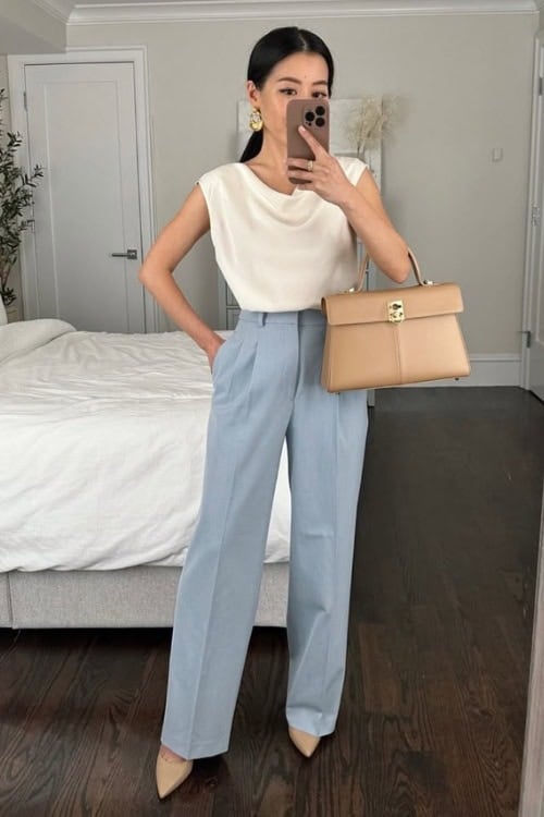 Cream blouse with high-waisted light blue trousers, perfect for spring workwear