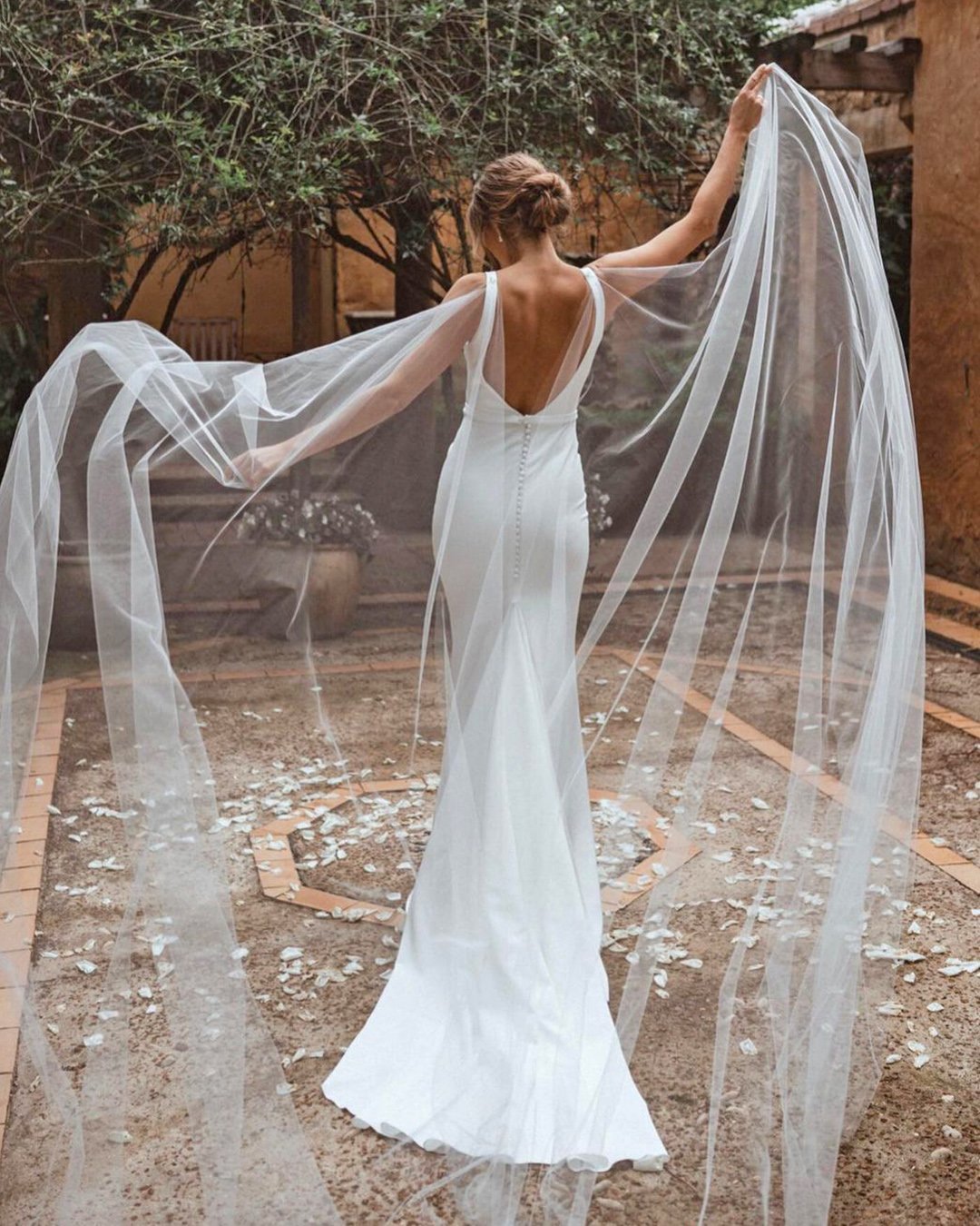 Sleek wedding gown with long veil