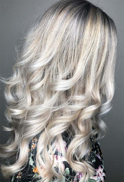 voluminous ash blonde curls with highlights