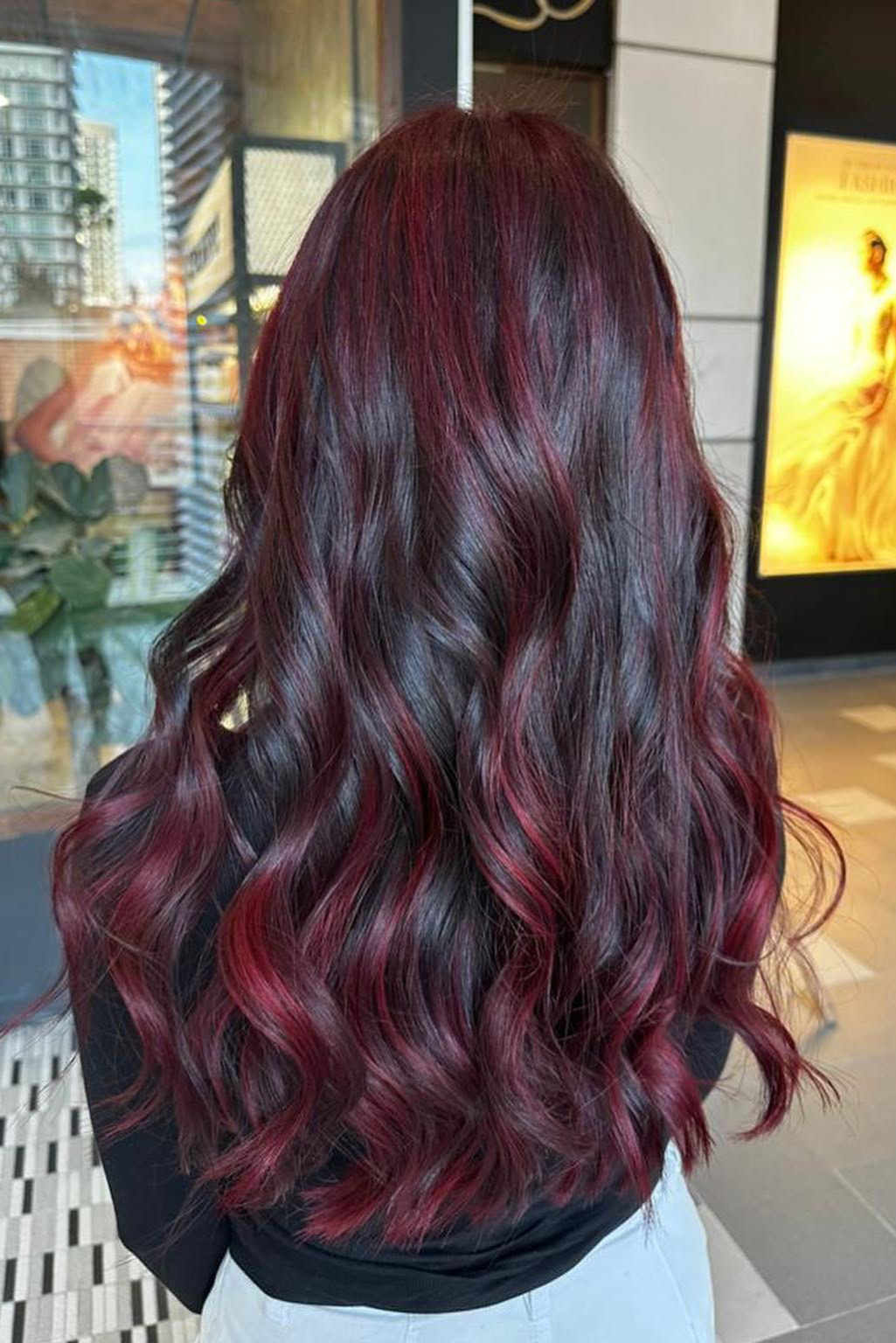 Red balayage on wavy hair for impact
