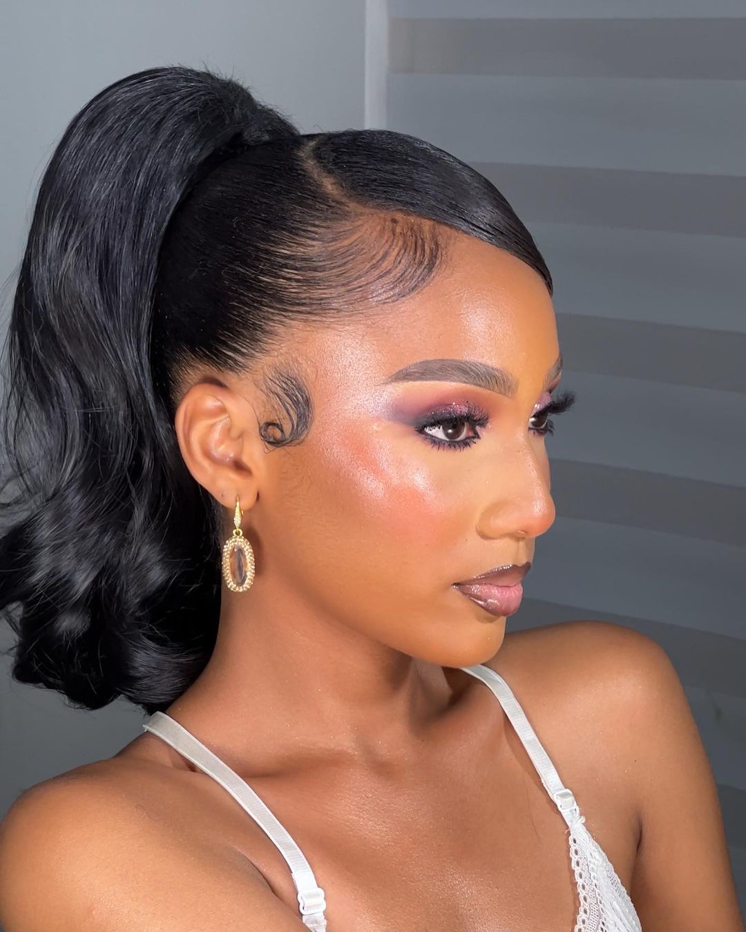 Sleek high ponytail with side swoop for Black girls