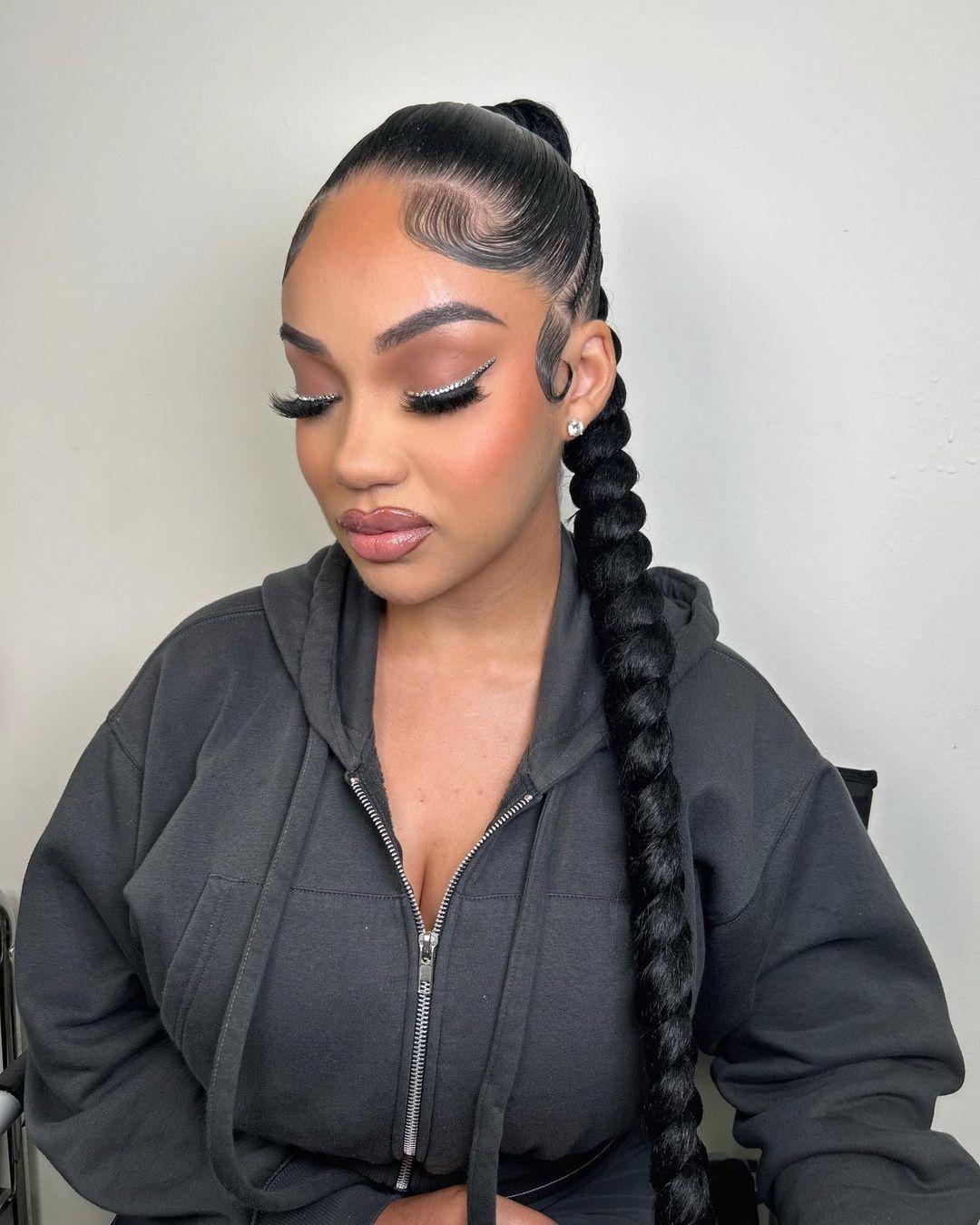 Sleek braided ponytail with twists
