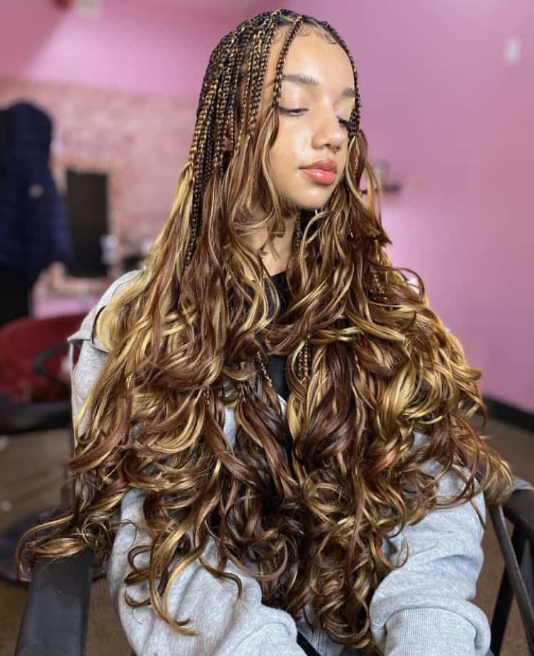 Long braids with blonde highlights and soft waves