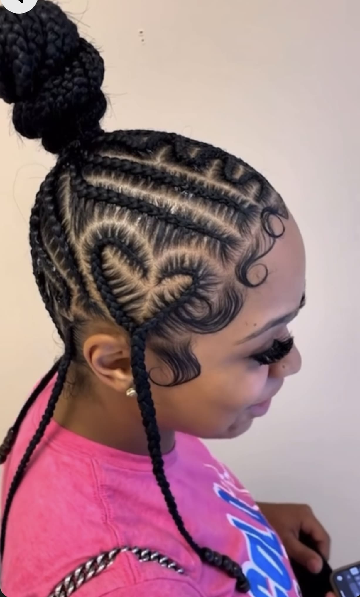 High bun with swirling cornrows, intricate design