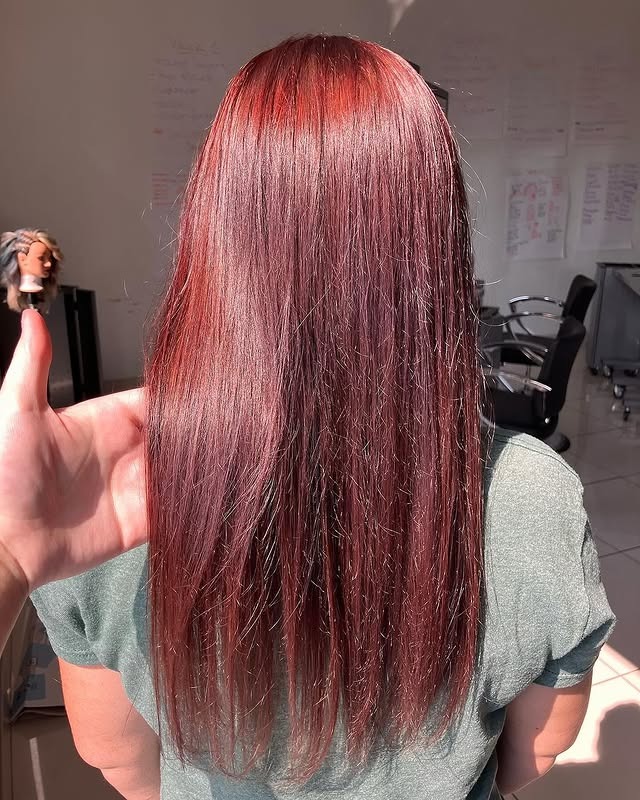 Sleek cherry red hair with straight finish