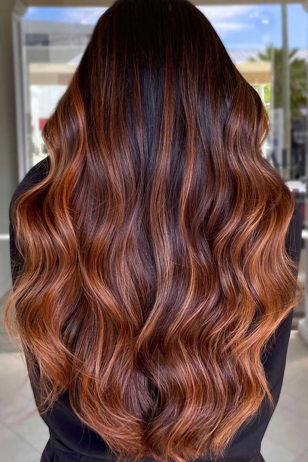 Long, wavy chocolate cherry hair with dimension