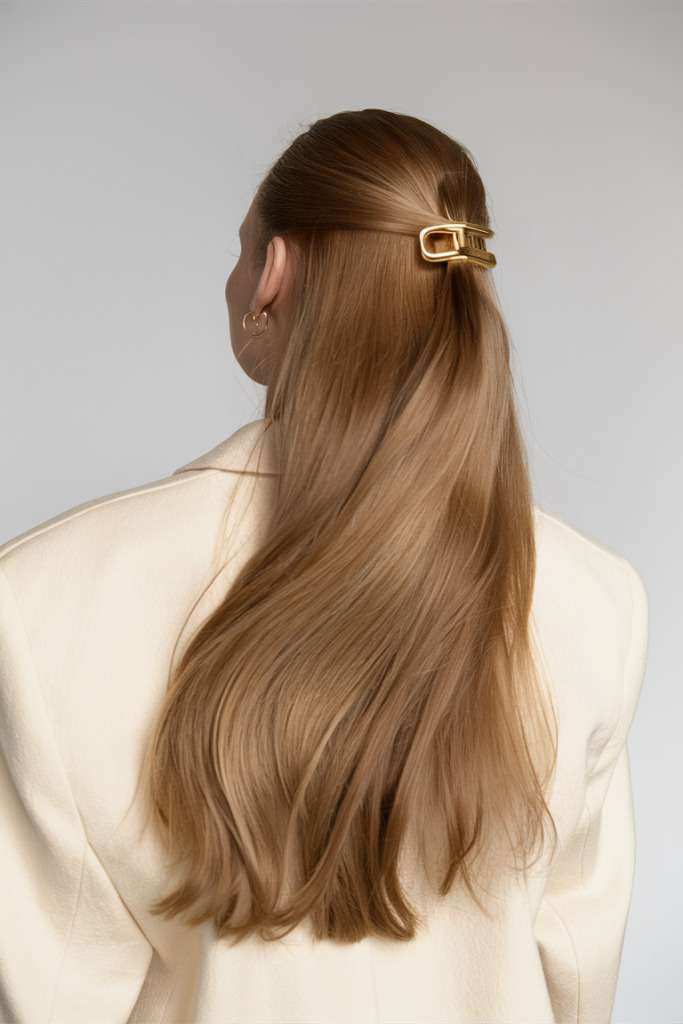 Classic half-up hairstyle with gold clip, elegant and timeless