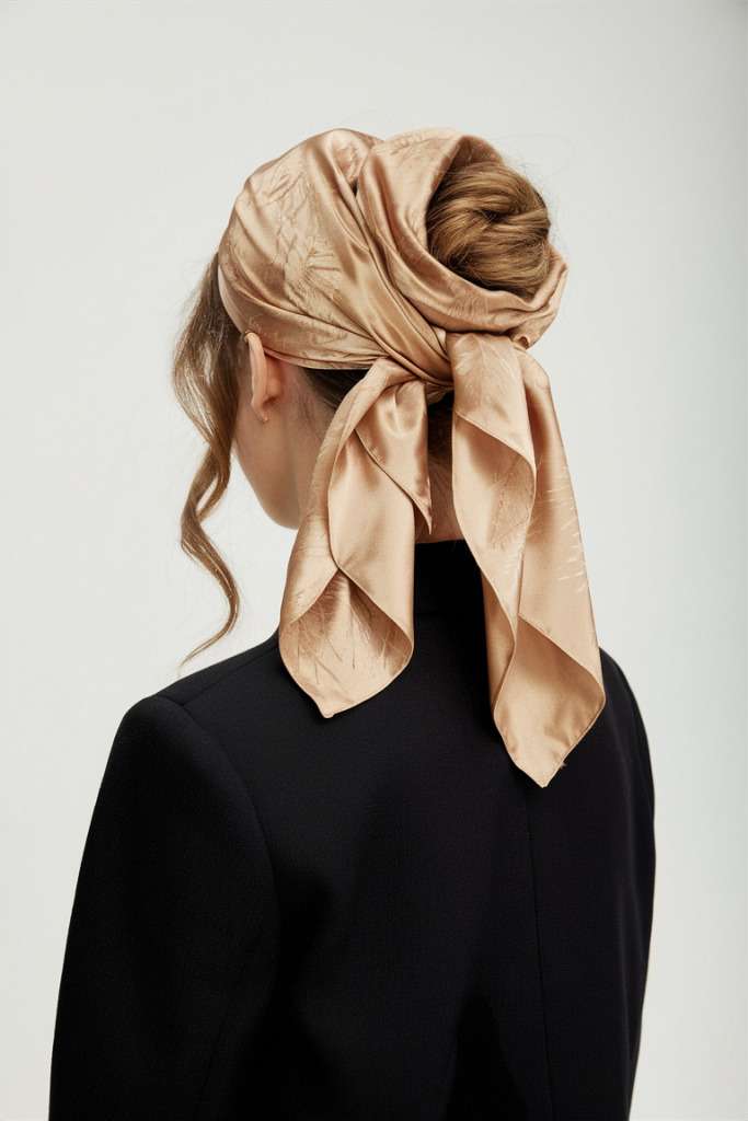 Silk scarf wrapped bun, elegant and sophisticated hairstyle
