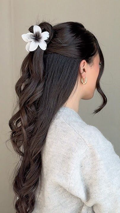 Elegant half-up hairstyle with floral clip, feminine and delicate
