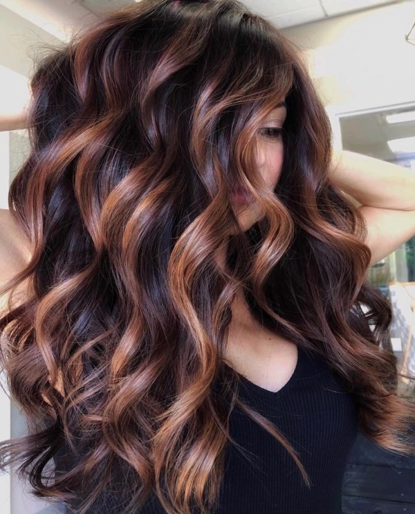 Long curly hair with copper highlights