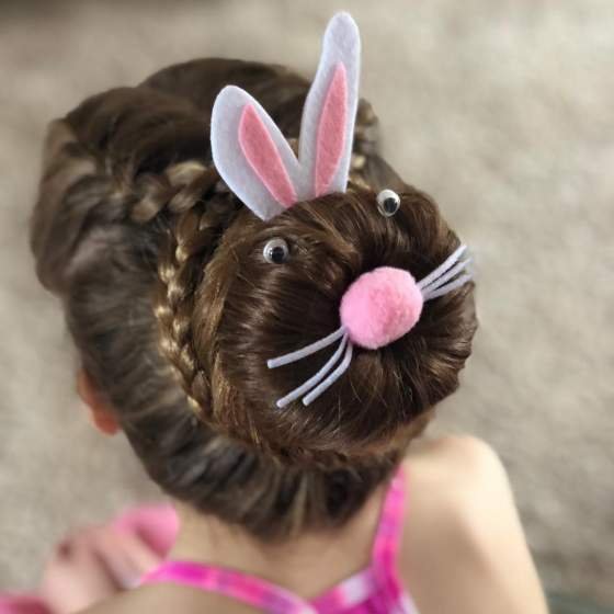 Cute bunny-themed bun hairstyle for Easter, complete with ears and whiskers.