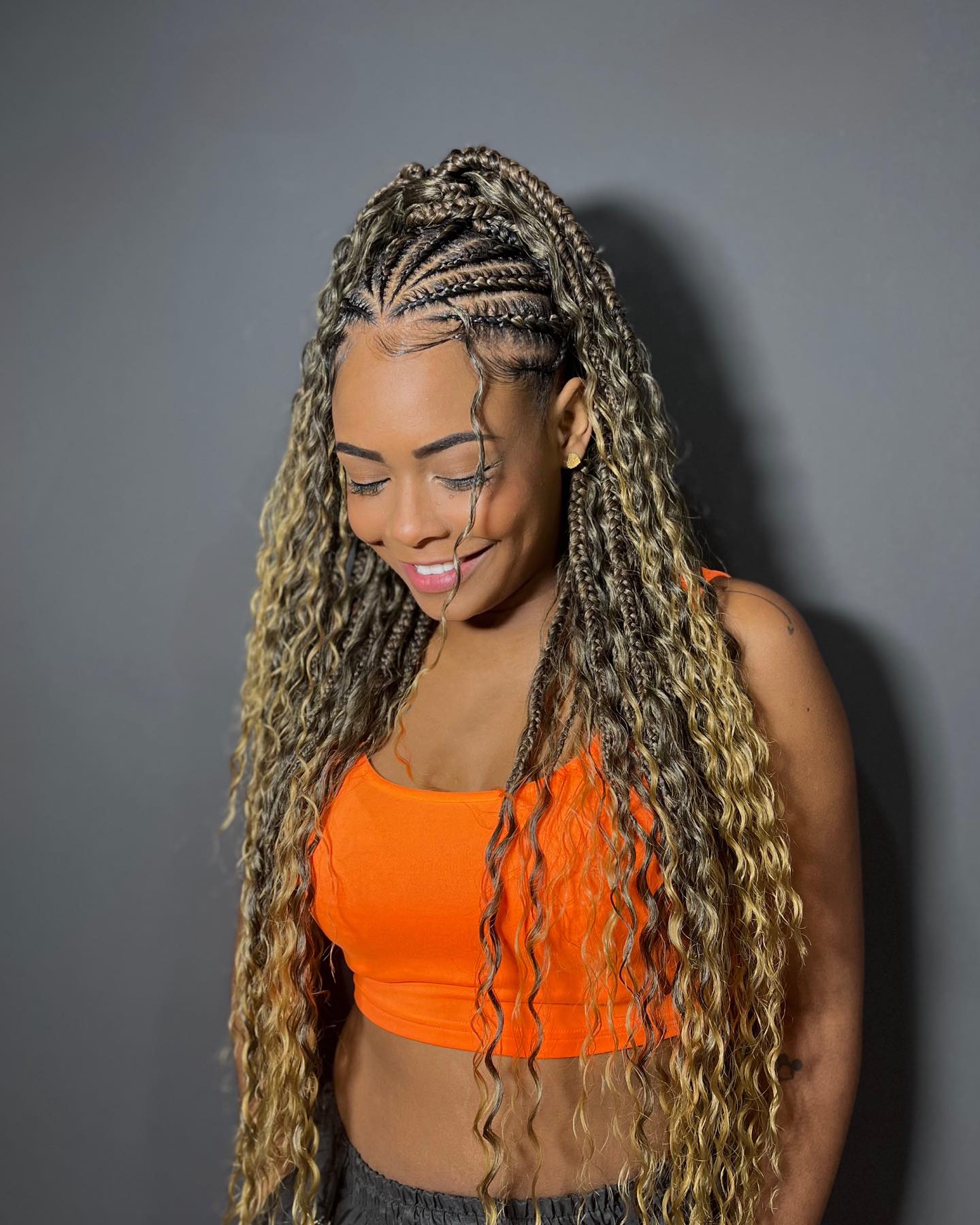 Bold half-up, half-down Fulani braids with blonde highlights